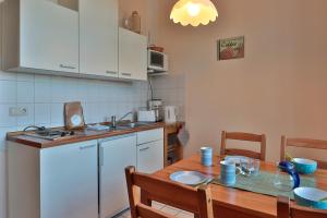 a kitchen with a wooden table and a table and a tableablish at Herrenhaus Blengow App.08 in Blengow
