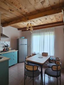 a kitchen with a table and chairs in a kitchen at LIME Shekvetili in Shekhvetili