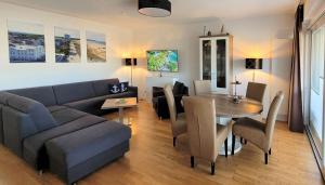 a living room with a couch and a table at Warnemünde Meeresrauschen 21707 in Warnemünde