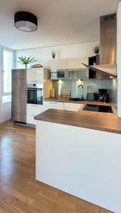 a large kitchen with white cabinets and a counter top at Warnemünde Meeresrauschen 21707 in Warnemünde