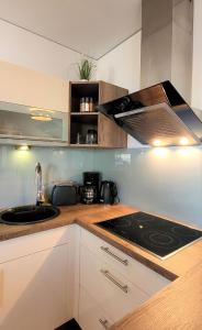 a kitchen with a sink and a stove top oven at Warnemünde Meeresrauschen 21707 in Warnemünde