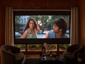 a television screen with a man and a woman on it at The Woodnest Tandi in Jibhi +40 photos