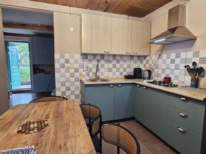 a kitchen with a wooden table and some chairs at LIME Shekvetili in Shekhvetili