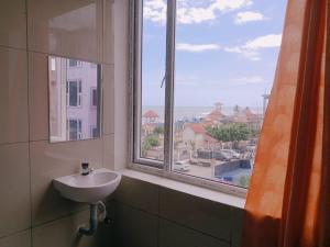 a bathroom with a sink and a window at GM Residency in Velankanni