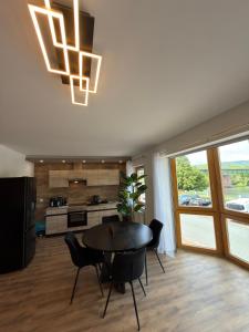 a kitchen and dining room with a table and chairs at Main Panorama Suite 97896 Freudenberg in Freudenberg am Main