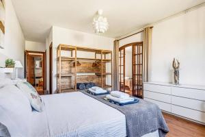 a bedroom with a white bed and a chandelier at Villa Tamyan by Villa Plus in Son Parc +25 photos