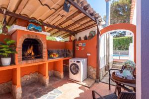 an outdoor patio with a fireplace and a stove at Villa Tamyan by Villa Plus in Son Parc