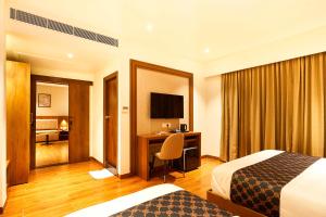 a hotel room with a bed and a desk at Liza Royale Hotel Near Chennai central Railway Station in Chennai