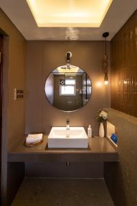 a bathroom with a sink and a mirror at SaffronStays Forest Edge in Siolim +49 photos