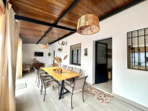 a dining room with a wooden table and chairs at Casa Mara in La Herrería