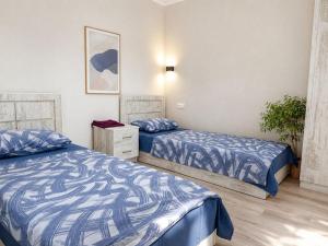a bedroom with two beds and a dresser in it at OUR House in Vagharshapat