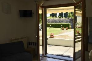 a sliding glass door with a view of a yard at Pian di luna in Sarzana