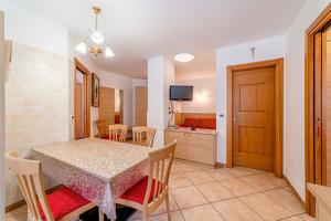a kitchen and dining room with a table and chairs at Appartamenti Ciesa Padon in Rocca Pietore +80 photos