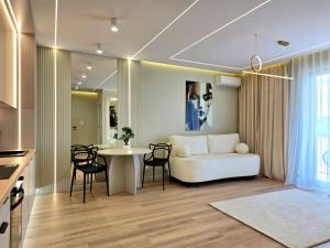 a living room with a white couch and a table at Apartament Ostródzka in Iława