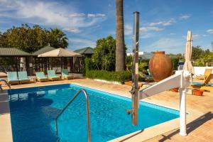 a swimming pool with a slide in a resort at Centre Algarve in Moncarapacho