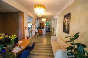 a living room with a couch and a table at Hotel Levante Cesenatico in Cesenatico