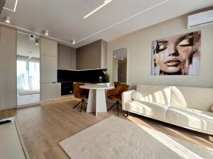 a living room with a white couch and a table at Apartament Ostródzka in Iława