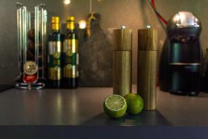 a counter with bottles of alcohol and a lime on it at Green Balcony Studio near Metro in Norsborg