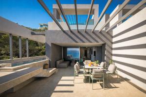a patio with a table and chairs on a house at Nerea Residences in Schinias