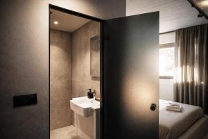 a bathroom with a sink and a mirror at Nerea Residences in Schinias +14 photos