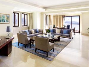 a living room with a couch and a table at Fairmont The Palm in Dubai +226 photos