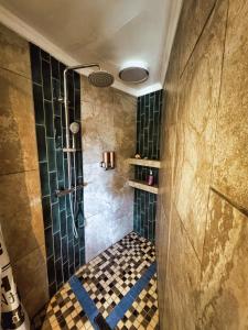 a bathroom with a shower with a checkered floor at Harties Lake View in Hartbeespoort +26 photos