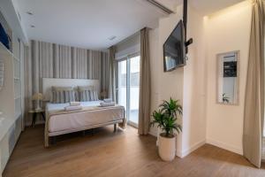 a bedroom with a bed and a tv on a wall at Letplanet Playa Park in Torremolinos +51 photos