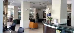 a bar in a restaurant with chairs and tables at Hotel Pace in San Giovanni Rotondo