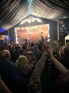 a crowd of people watching a man on a stage at Hotelletvidfjallet in Transtrand