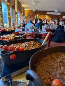 a bunch of food in pans on a table at Hotelletvidfjallet in Transtrand