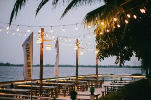 a group of tables with lights and a body of water at Marina Bến Du Thuyền in Ấp Long Ðại