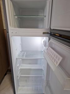 an empty refrigerator with its door open in a kitchen at Silver room 3 in Zatoka
