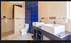 a bathroom with a sink and a toilet and a shower at Elikia in Pretoria
