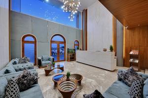 a living room with two couches and a table at Ira by Orchid Dwarka in Dwarka