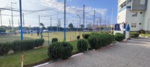 a tennis court with people on a court at Appartement Résidence fermée avec piscine in Ben Slimane
