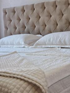 a bed with white sheets and pillows on it at Silver room 3 in Zatoka