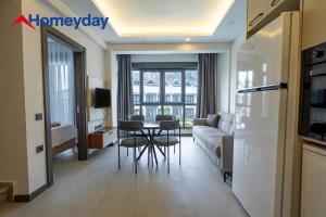 a living room with a couch and a table at Whitestone Homes in Antalya