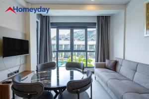 a living room with a couch and a table and chairs at Whitestone Homes in Antalya