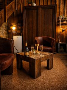 a room with two chairs and a table with wine glasses at Chez Cathy in Villandraut