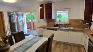 a kitchen with a table and a sink and a table and chairs at Ferienwohnung Regina in Undenheim