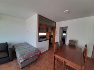 a room with a table and a bed and a dining room at Parana in Rosario