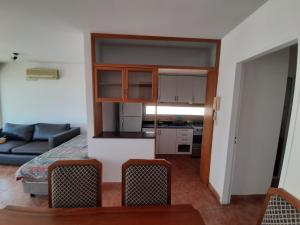 a small living room with a couch and a kitchen at Parana in Rosario
