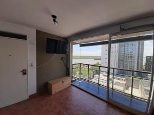 a room with a balcony with a view of the water at Parana in Rosario