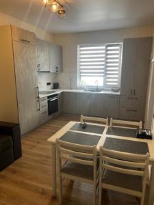 a kitchen with a table and chairs in a room at Anna in Rivne