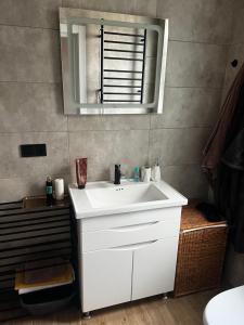 a bathroom with a white sink and a mirror at Anna in Rivne