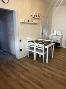 a dining room with a white table and chairs at Anna in Rivne +1 photo
