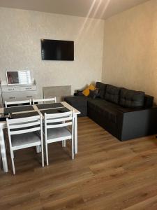 a living room with a couch and a table and chairs at Anna in Rivne