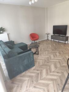 a living room with a couch and a television at Apartament Isabell in Busko-Zdrój