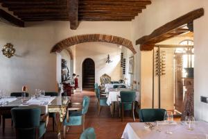 a restaurant with tables and chairs in a room at Castello Di Tornano Wine Relais in Gaiole in Chianti