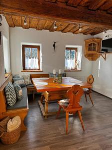 a living room with a wooden table and a couch at Haus Wildblick in Fladnitz an der Teichalm